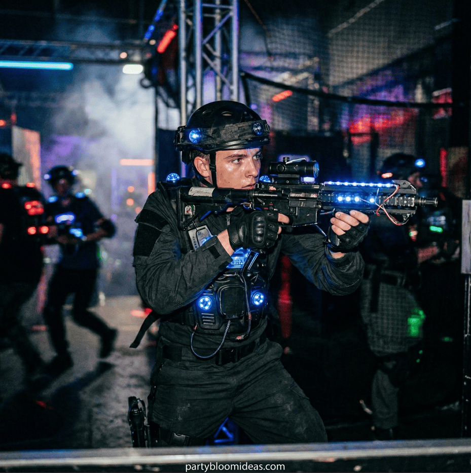 Young teens playing laser tag at a birthday party.