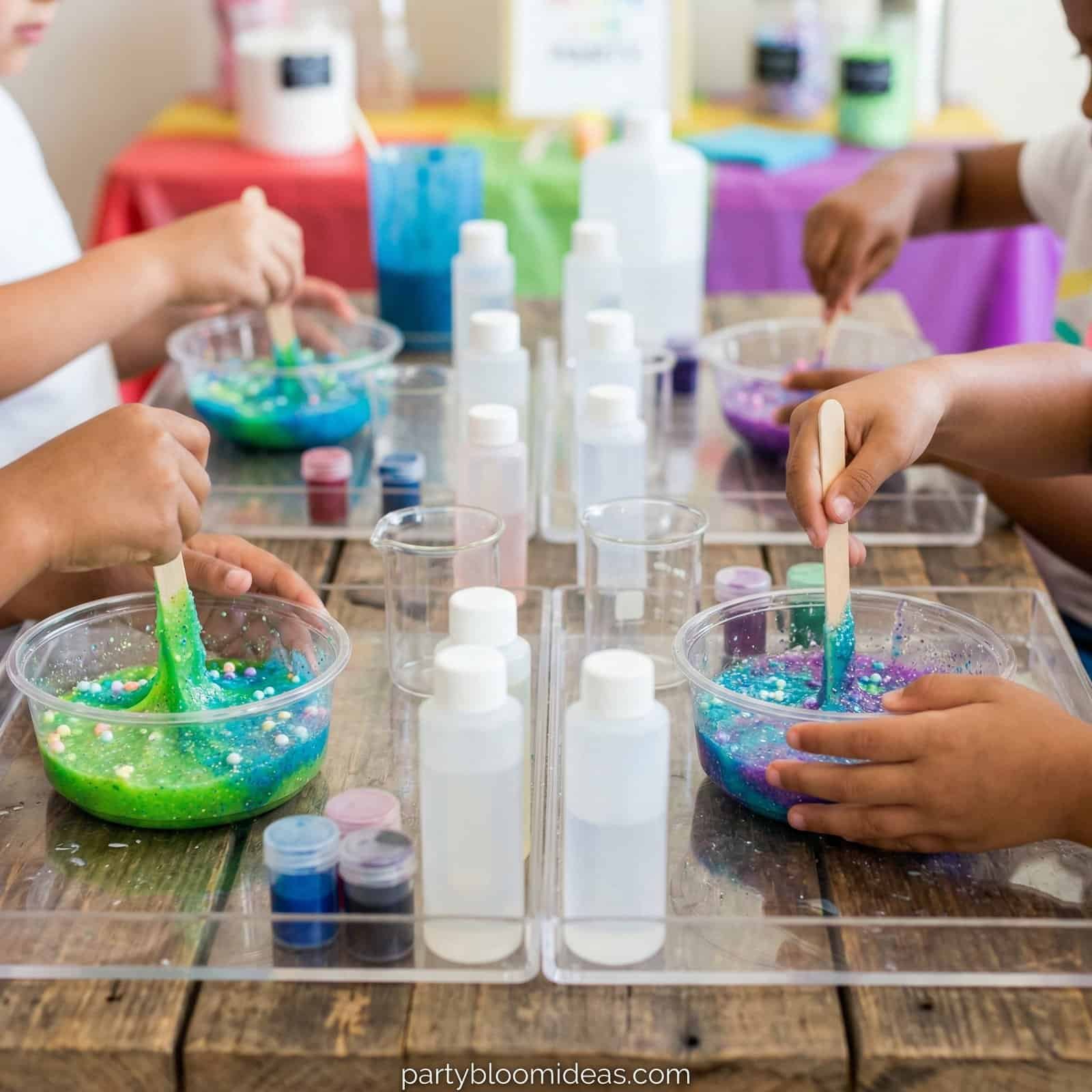 Bright slime bowls with kids mixing colorful glitter for a fun birthday celebration.