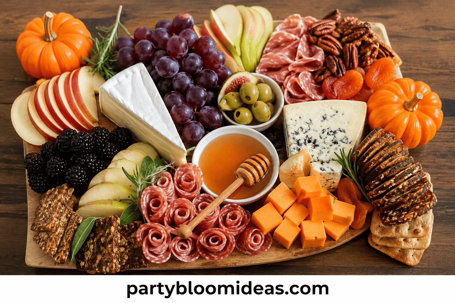 Fall harvest charcuterie board with cheeses, meats, grapes, figs, and small gourds