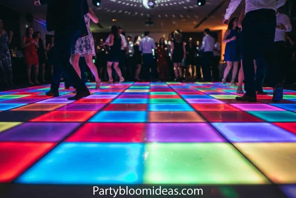 Colorful LED dance floor lights creating a vibrant disco party atmosphere indoors.