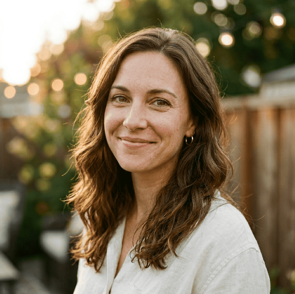 Maya, founder of Party Bloom Ideas, smiling outdoors in natural light.