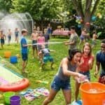 Kids water slide and outdoor party fun scene.