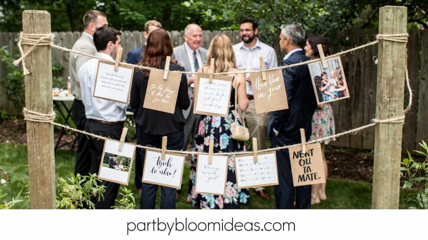 Guests at an outdoor party beside a twine photo string display with clothespins