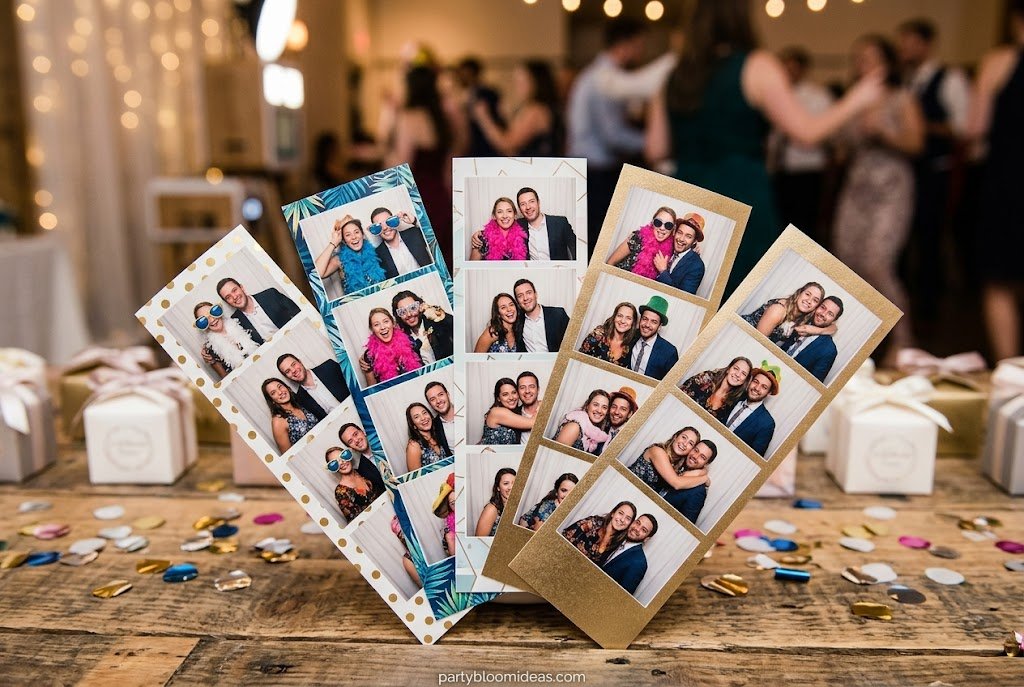 Guests holding personalized photo booth print strips as memorable keepsake party favors.