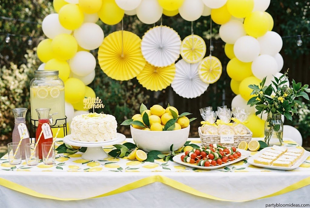 Little Lemon Sunshine first birthday party theme with yellow decorations and fresh lemons